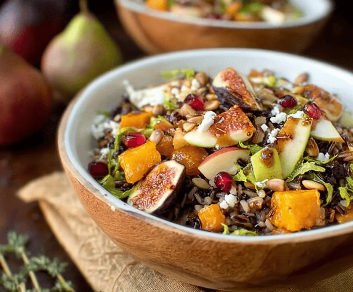 Colorful wild rice harvest bowls topped with fresh vegetables and drizzled with fig balsamic vinaigrette, showcasing a healthy and vibrant meal option.