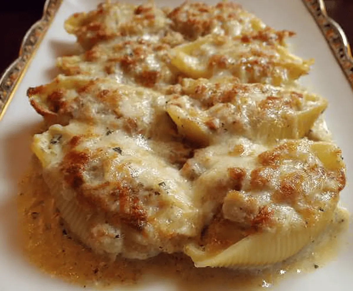 Delicious Thanksgiving leftovers stuffed shells with melted cheese and savory fillings on a festive plate.