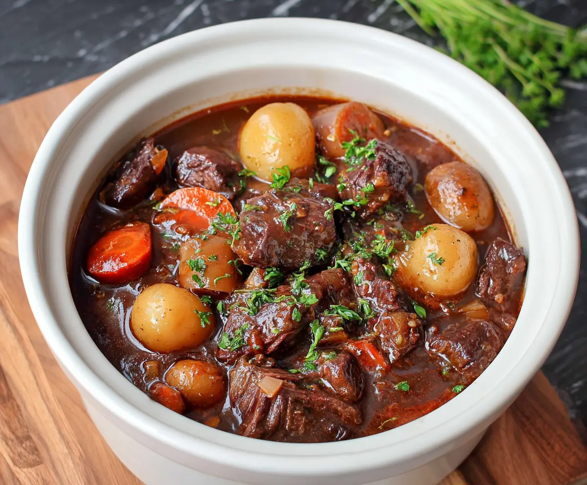 Delicious slow-cooker beef bourguignon with tender beef, carrots, and mushrooms in rich red wine sauce