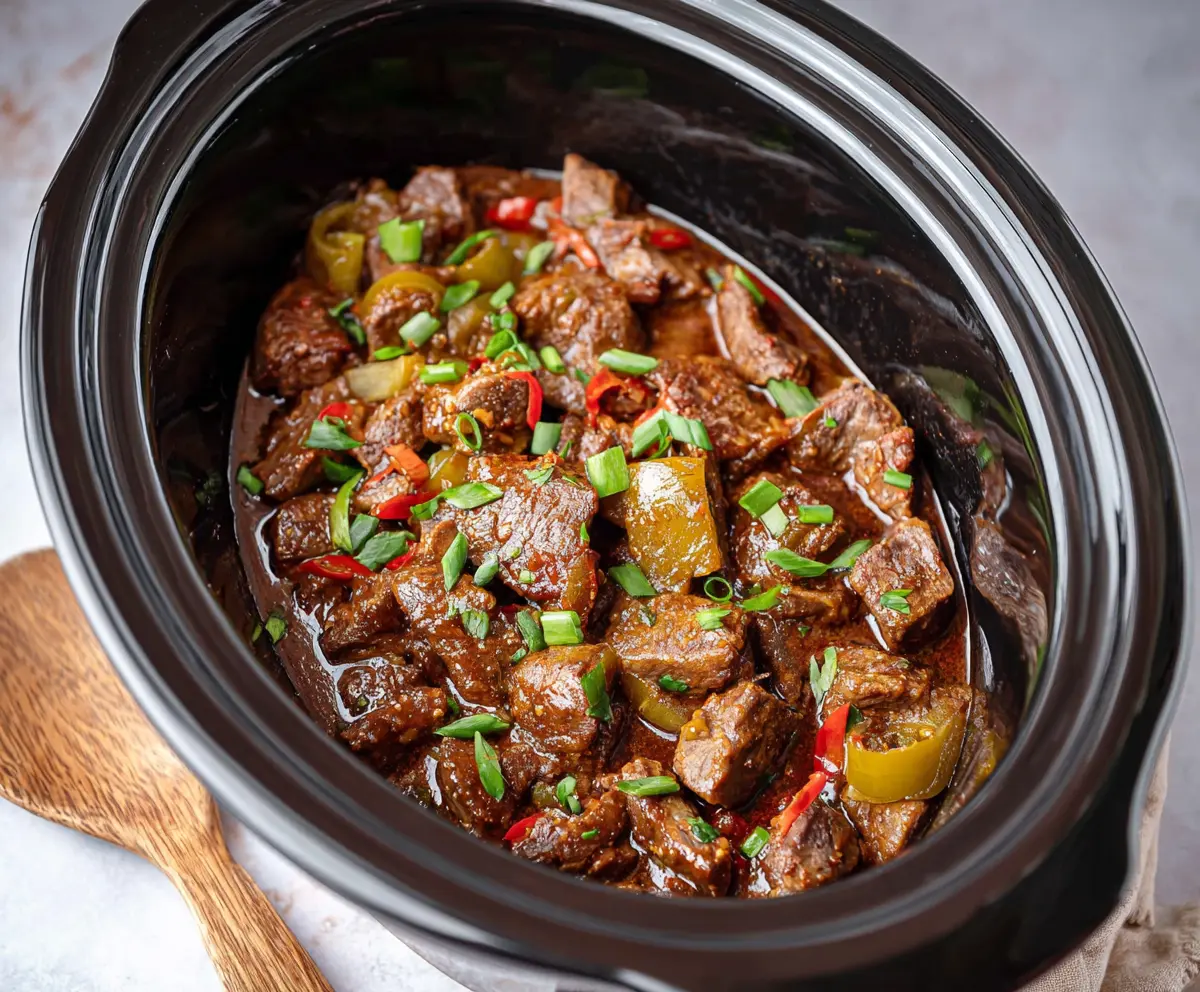 Savory Crockpot Mississippi Steak Bites served in a bowl, garnished with herbs, perfect for a flavorful appetizer or main course.