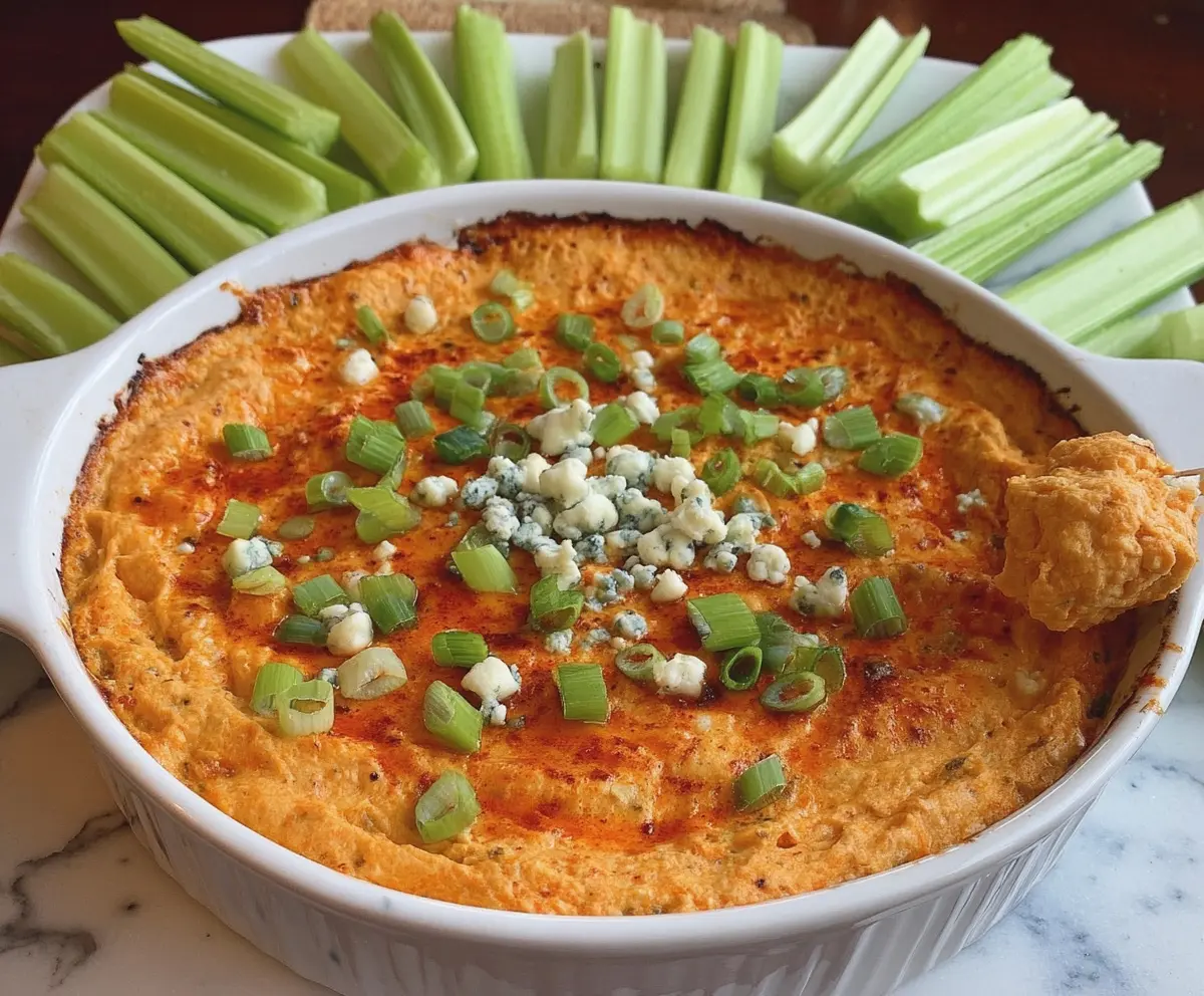 Creamy Buffalo Cauliflower Dip garnished with chopped green onions for a spicy appetizer.
