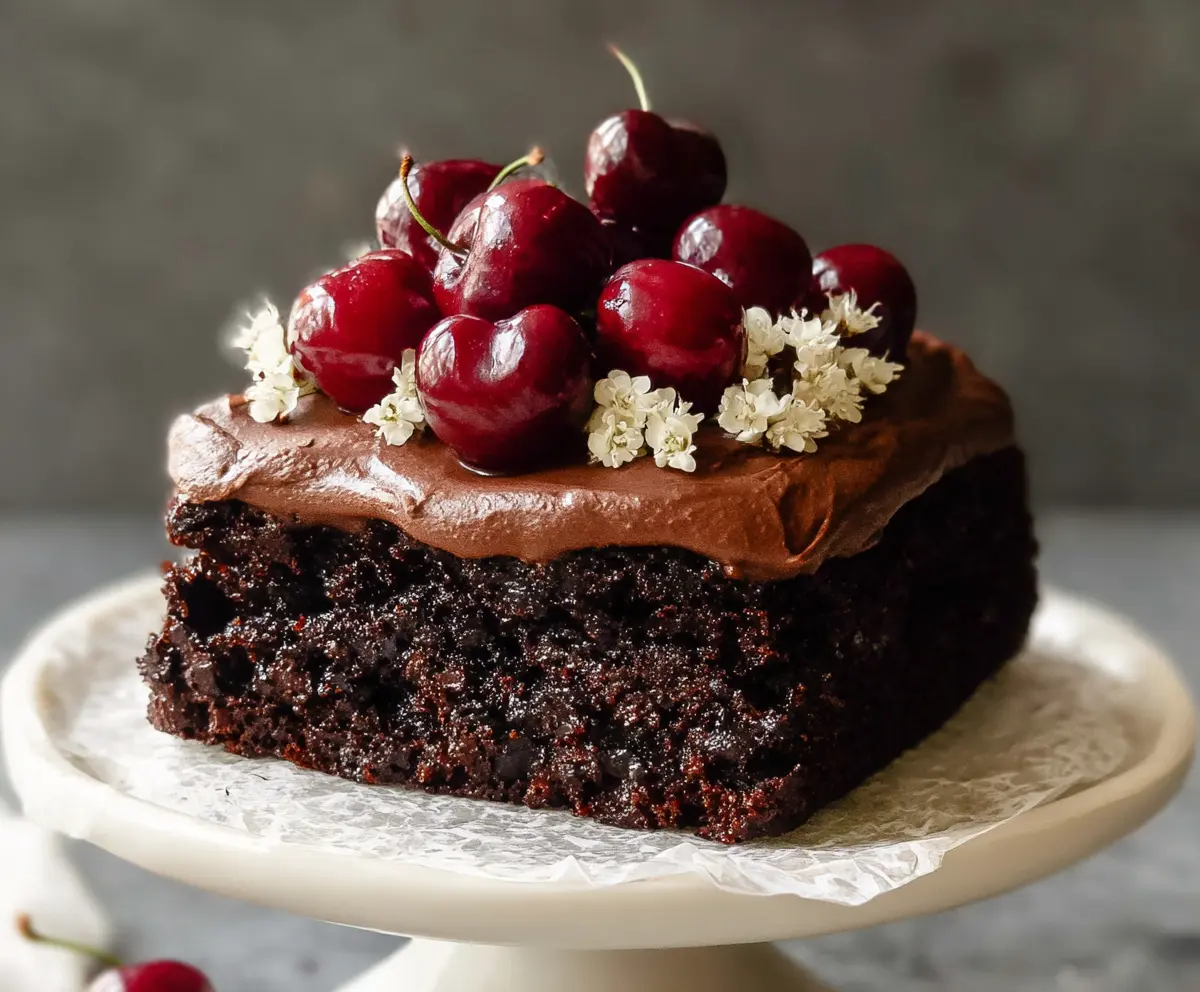 Delicious homemade chocolate cherry cake with rich frosting and fresh cherries on top