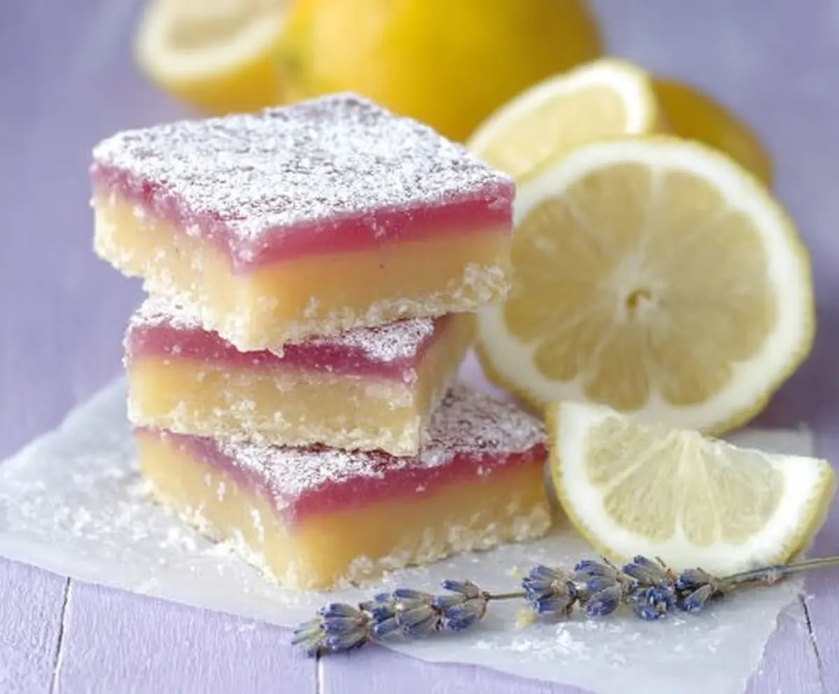 Delicious lavender lemon bars on a white plate with fresh lavender garnish